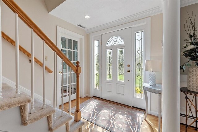 134 Reed Farm Rd, Boxborough, MA 01719 - entrance foyer featuring baseboard heating, stairway, crown molding, baseboards, and recessed lighting