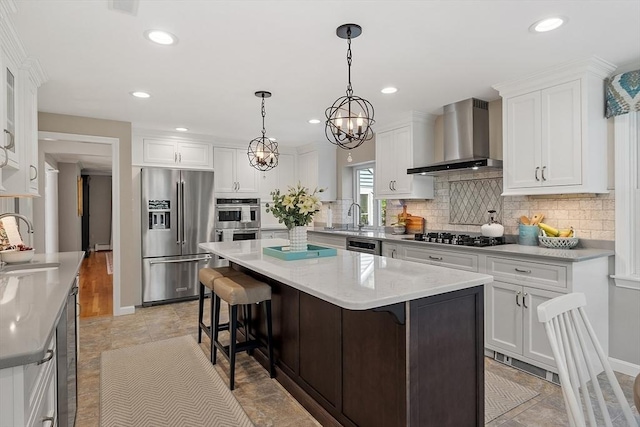 134 Reed Farm Rd, Boxborough, MA 01719 - kitchen featuring stainless steel appliances, wall chimney exhaust hood, a sink, a center island, and white cabinets