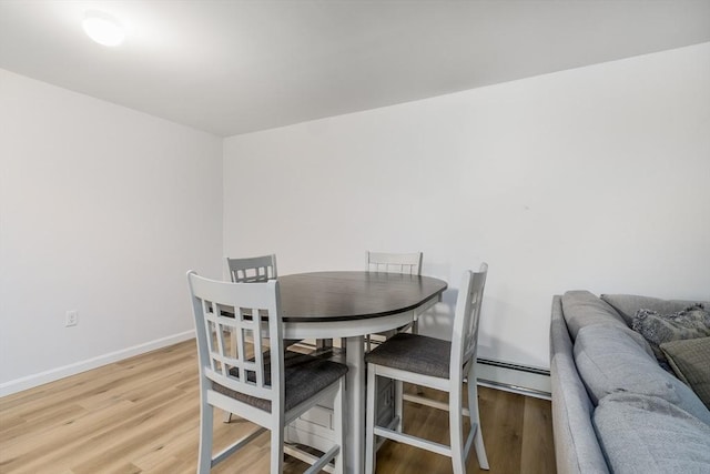 dining room featuring hardwood / wood-style floors and a baseboard radiator