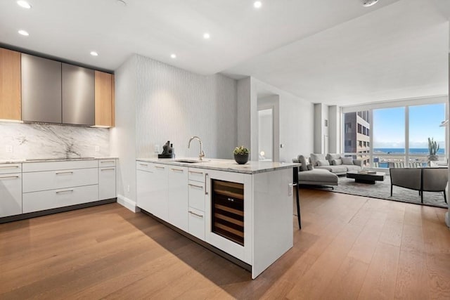 240 Devonshire St Unit 4210, Boston, MA 02110 - kitchen featuring modern cabinets, wine cooler, a peninsula, light wood-type flooring, and recessed lighting