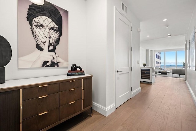240 Devonshire St Unit 4210, Boston, MA 02110 - hallway with light wood-type flooring, baseboards, beverage cooler, and recessed lighting