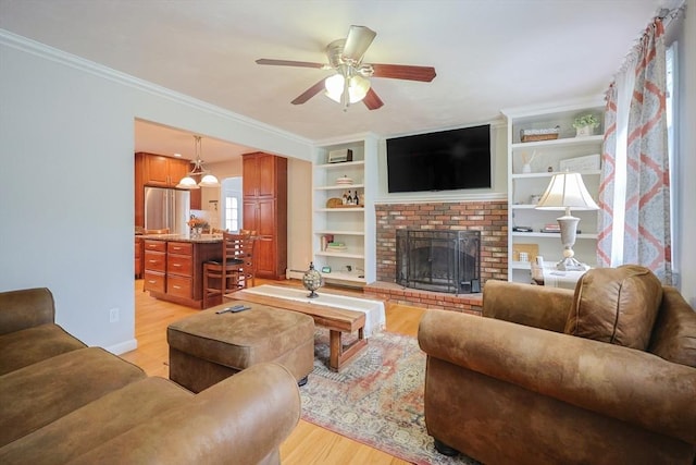 421 Gray Ter, Dighton, MA 02764 - living room featuring light wood finished floors, a ceiling fan, a brick fireplace, ornamental molding, and a baseboard radiator