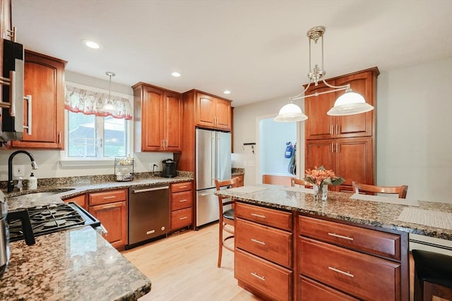 421 Gray Ter, Dighton, MA 02764 - kitchen featuring stainless steel appliances, a sink, light wood finished floors, pendant lighting, and brown cabinetry