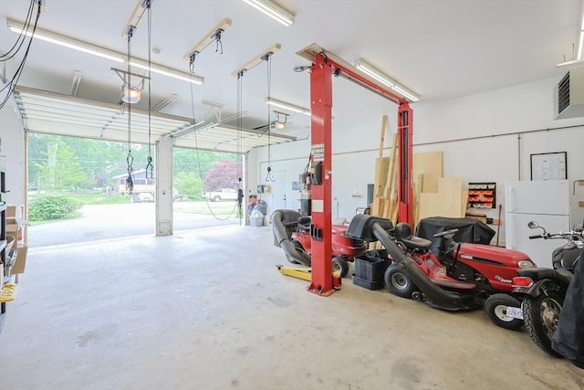 421 Gray Ter, Dighton, MA 02764 - garage featuring a garage door opener and freestanding refrigerator