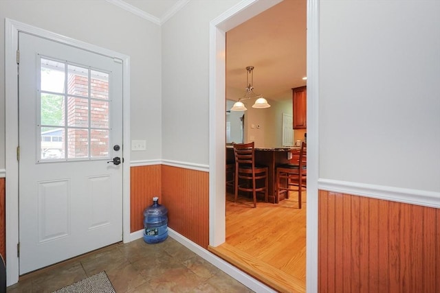 421 Gray Ter, Dighton, MA 02764 - doorway to outside featuring a wainscoted wall, ornamental molding, and wood walls