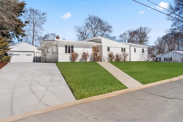 view of front facade featuring a front yard, an outbuilding, a garage, and a chimney