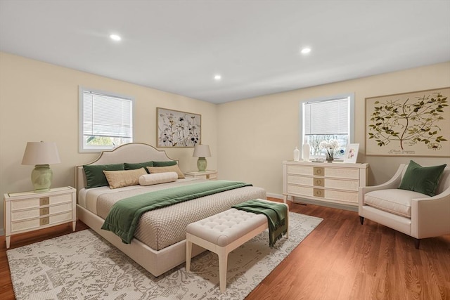 bedroom featuring recessed lighting, multiple windows, and wood finished floors