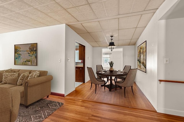 dining room with baseboards and wood finished floors