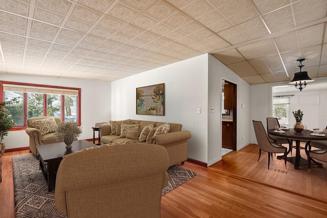 living area with wood finished floors and baseboards