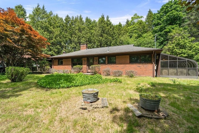 260 Landham Rd, Sudbury, MA 01776 - view of front facade featuring brick siding and a front lawn