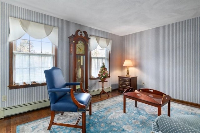 sitting room featuring baseboard heating and wood-type flooring