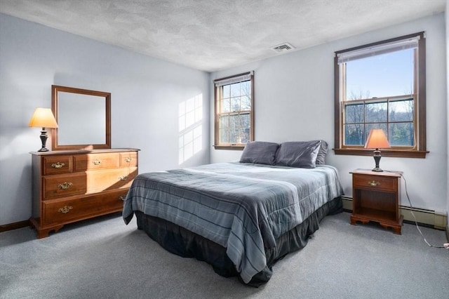 bedroom with light carpet, a textured ceiling, and baseboard heating