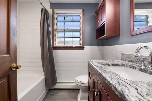 full bathroom with vanity, tile patterned floors, toilet, tile walls, and a baseboard radiator