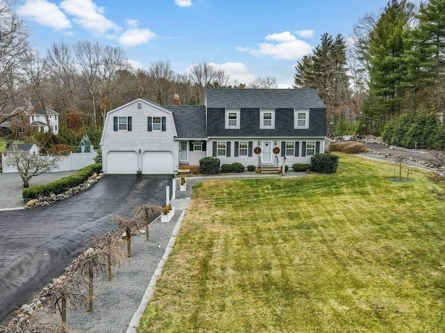 view of front of property featuring a garage and a front lawn