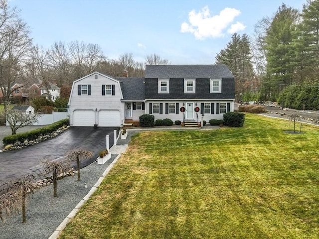 new england style home featuring covered porch, a front yard, and a garage