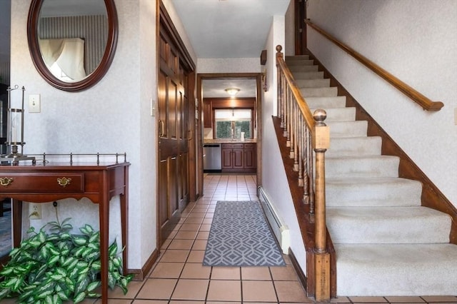 stairs featuring tile patterned flooring and a baseboard radiator