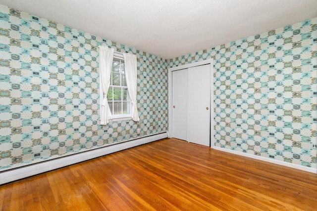 378 Linebrook Rd, Ipswich, MA 01938 - unfurnished room featuring wallpapered walls, a baseboard radiator, baseboards, and wood finished floors