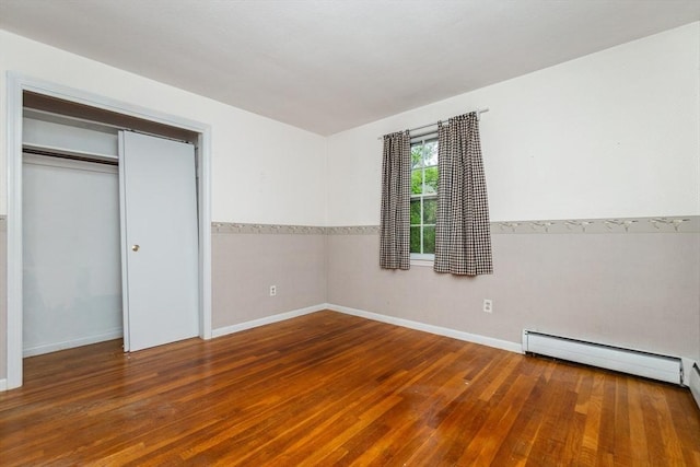 378 Linebrook Rd, Ipswich, MA 01938 - unfurnished bedroom featuring wood-type flooring, baseboards, a closet, and a baseboard heating unit