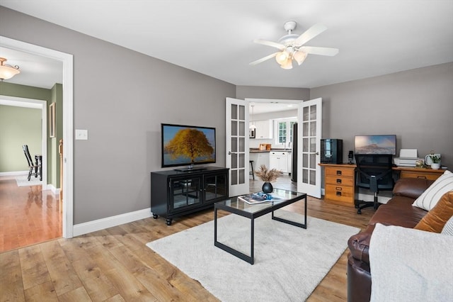 100 Overlook Ter, Dracut, MA 01826 - living area with french doors, light wood-type flooring, ceiling fan, and a desk