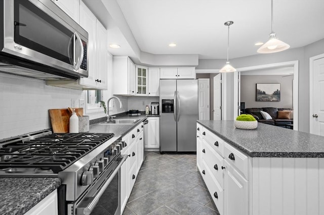 100 Overlook Ter, Dracut, MA 01826 - kitchen with appliances with stainless steel finishes, dark countertops, recessed lighting, and glass insert cabinets