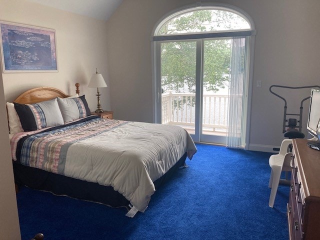 bedroom featuring lofted ceiling, access to outside, multiple windows, and carpet flooring