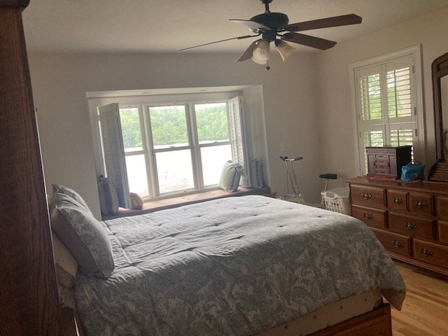 bedroom with ceiling fan and light hardwood / wood-style floors