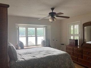 bedroom featuring multiple windows and ceiling fan