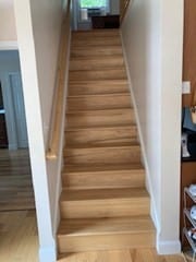 staircase with light hardwood / wood-style floors