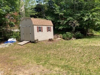 view of outbuilding featuring a yard