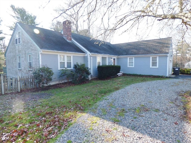 back of house with a lawn