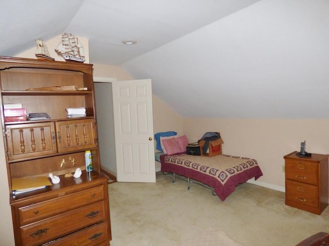 bedroom featuring light carpet and lofted ceiling