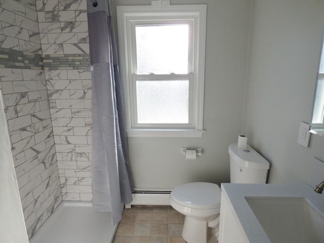 bathroom with curtained shower, baseboard heating, tile patterned flooring, toilet, and vanity