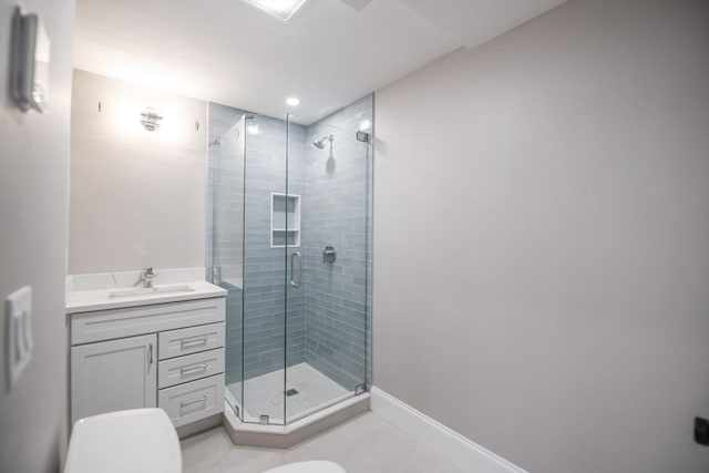 bathroom with vanity, a shower with shower door, toilet, and tile patterned flooring