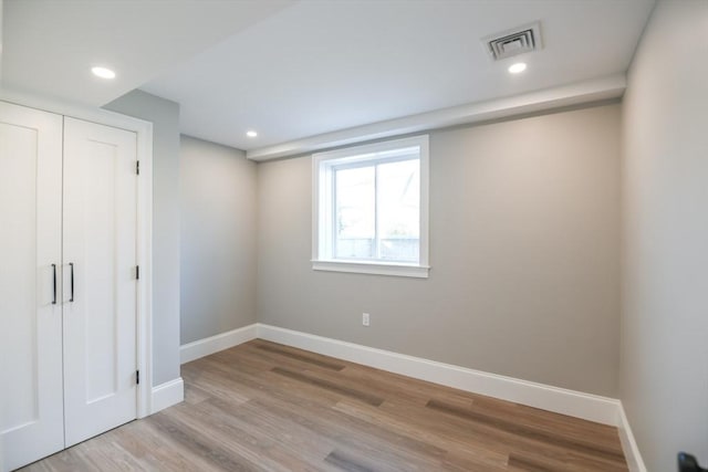 unfurnished bedroom with a closet and light hardwood / wood-style flooring