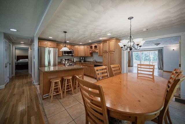 dining space featuring a chandelier, recessed lighting, and baseboards