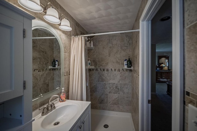full bath with a shower stall and vanity