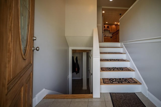 stairway featuring recessed lighting, baseboards, and tile patterned flooring