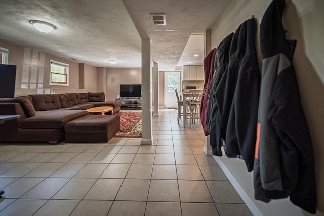 living room featuring light tile patterned flooring and baseboards
