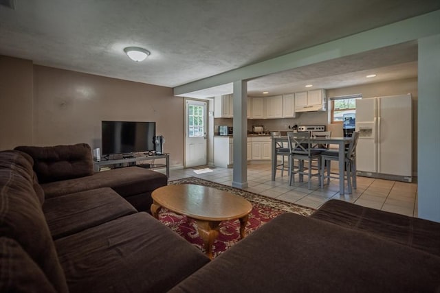 living room with light tile patterned flooring and recessed lighting