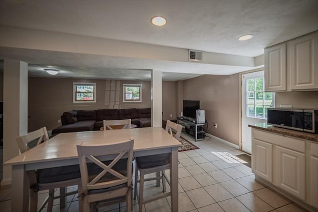 dining area featuring light tile patterned floors, baseboards, and recessed lighting