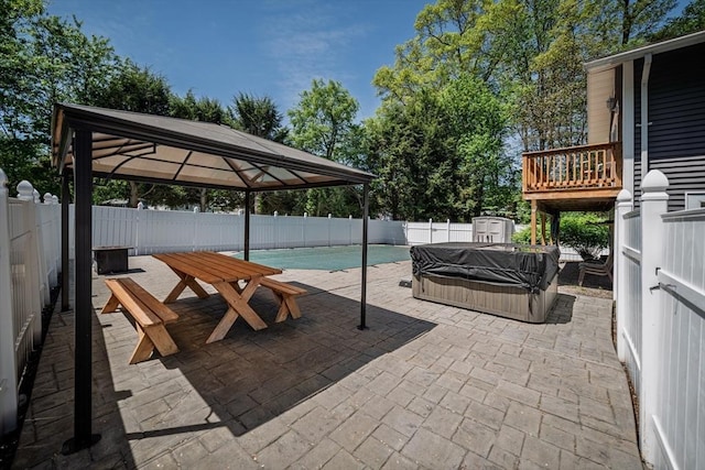 view of swimming pool featuring a gazebo, a fenced backyard, a patio area, and a covered hot tub