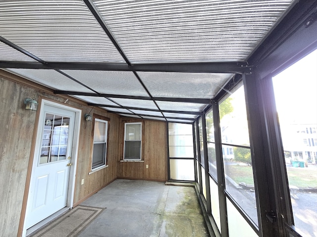 unfurnished sunroom featuring lofted ceiling