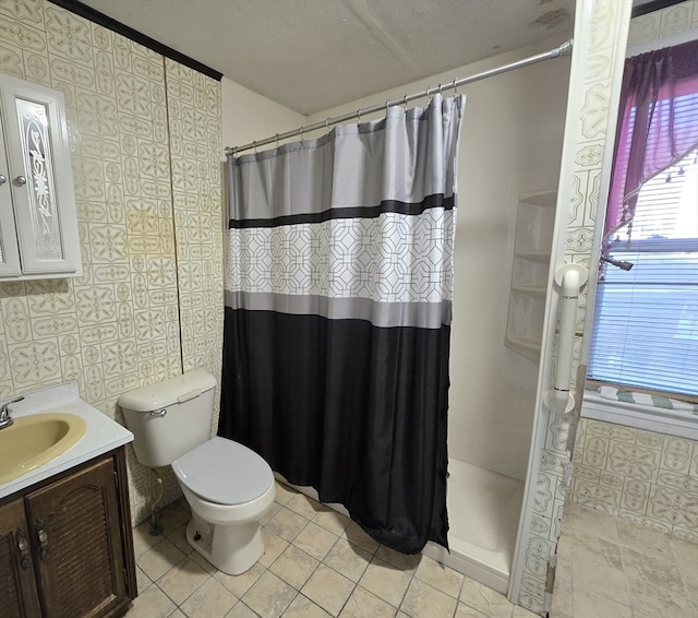 bathroom with vanity, tile patterned floors, toilet, and curtained shower