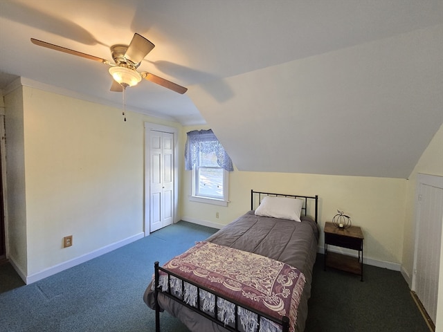 carpeted bedroom featuring a closet, lofted ceiling, and ceiling fan