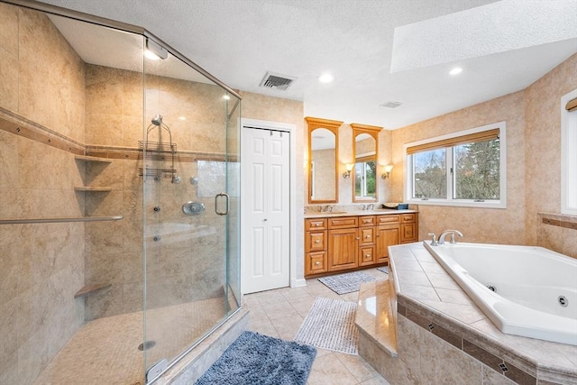 full bath with visible vents, tile patterned flooring, a stall shower, a tub with jets, and vanity