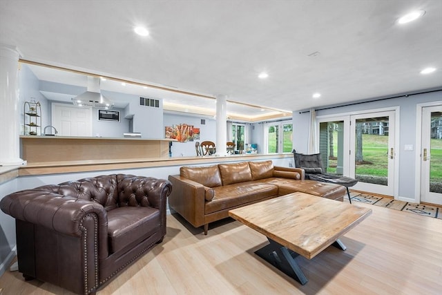 living area featuring light wood-type flooring, recessed lighting, and visible vents