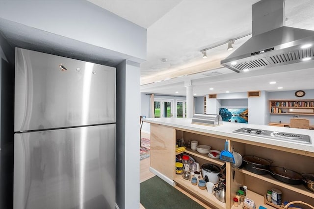 kitchen with exhaust hood, electric stovetop, light countertops, freestanding refrigerator, and recessed lighting