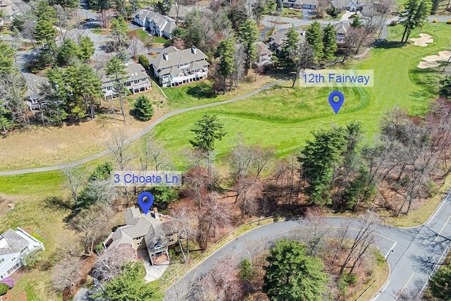 drone / aerial view with a residential view and golf course view
