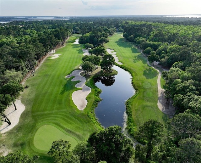 drone / aerial view with a water view and view of golf course