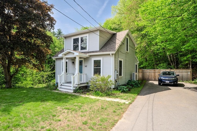 view of front of home featuring asphalt driveway and a shingled roof